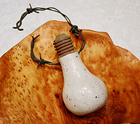 Bright Idea - Raku lightbulb with infused barbed wire